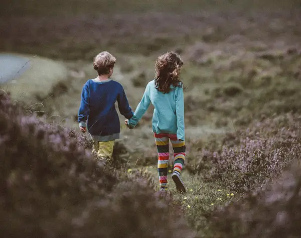 girl holding hands with boy