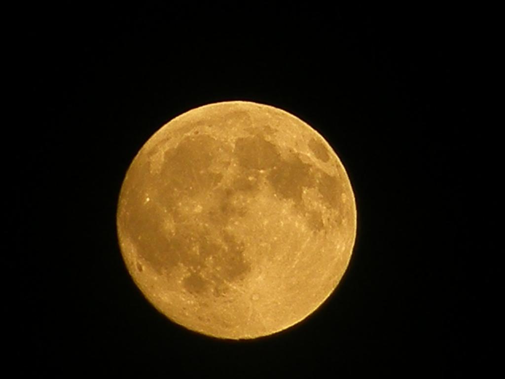 A straight on shot of the moon at night has been done time and time again, instead try to include a few ghostly clouds, and apply the rule of thirds for the sake of the composition  