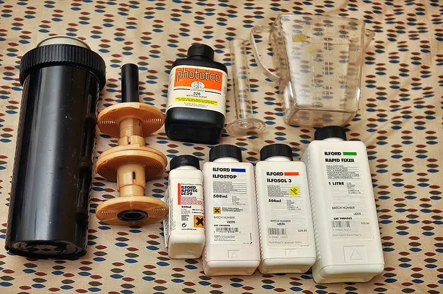 A selection of equipment necessary to develop black and white negatives, including a developing tank, fixer, and developer. Photo by fraew.