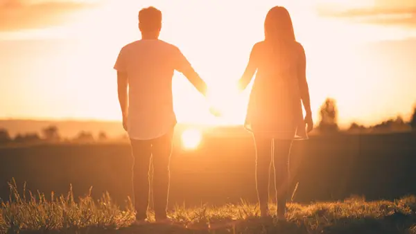 man holding hands with woman