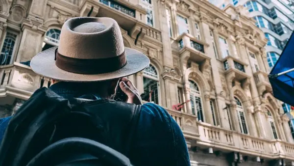 man in front of historical building