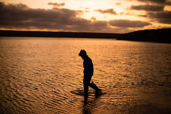 boy in water twilight