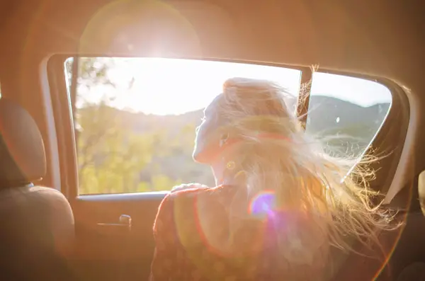 woman looking out of car window