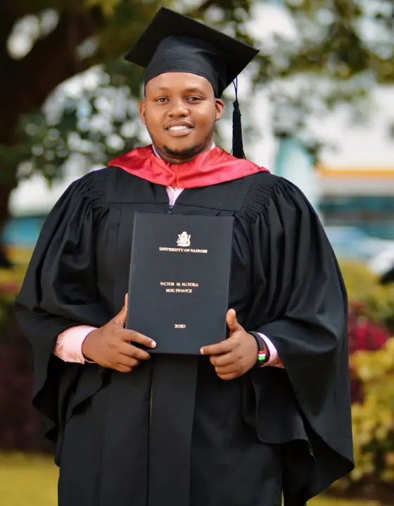 student holding diploma