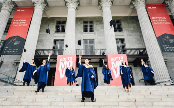 graduates with hats flying