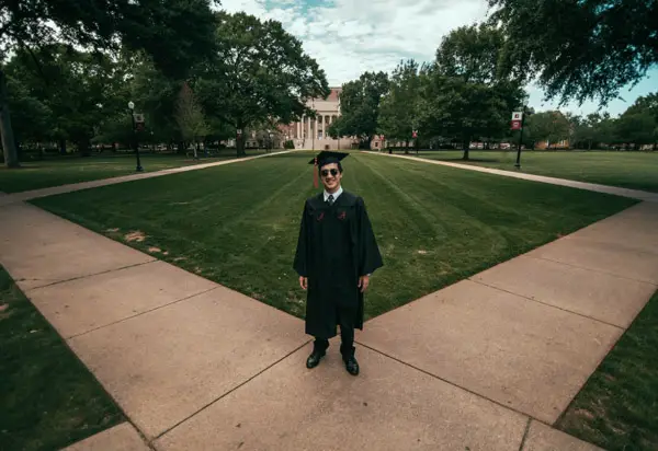 male graduate in front of building