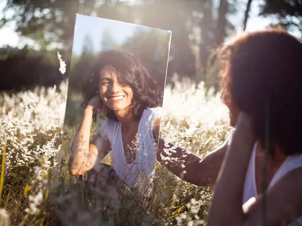 woman looking in mirror