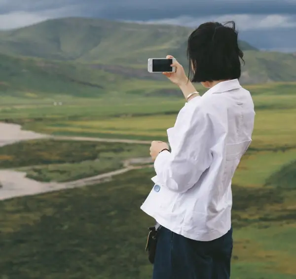 Girl snapping a photo with her phone