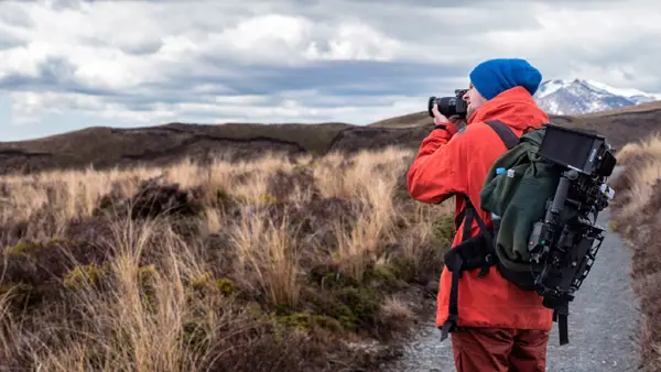 man photographing a landscape
