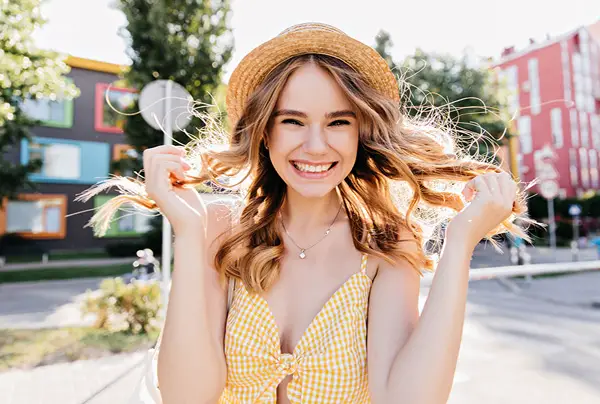 smiling girl holding her hair