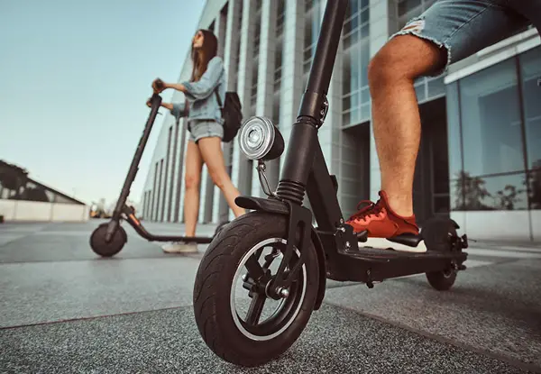 man and woman on scooters