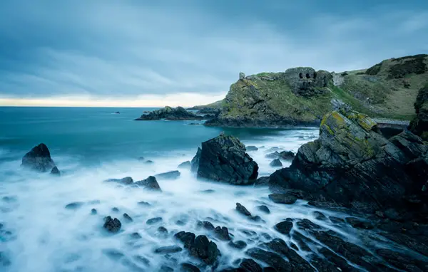 Photo of ruins along the sea coast taken at slow shutter speed