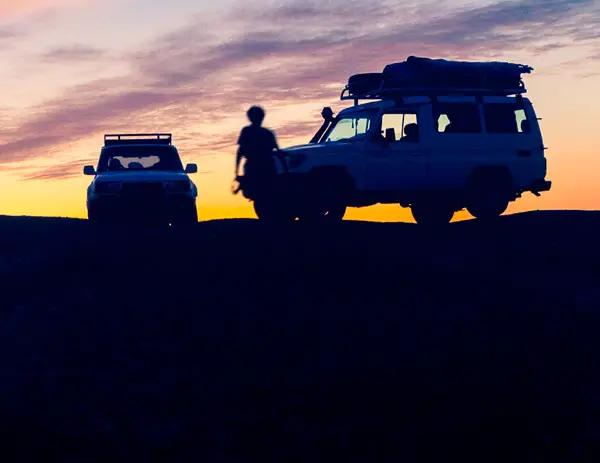 low light sunset photo of cars and people