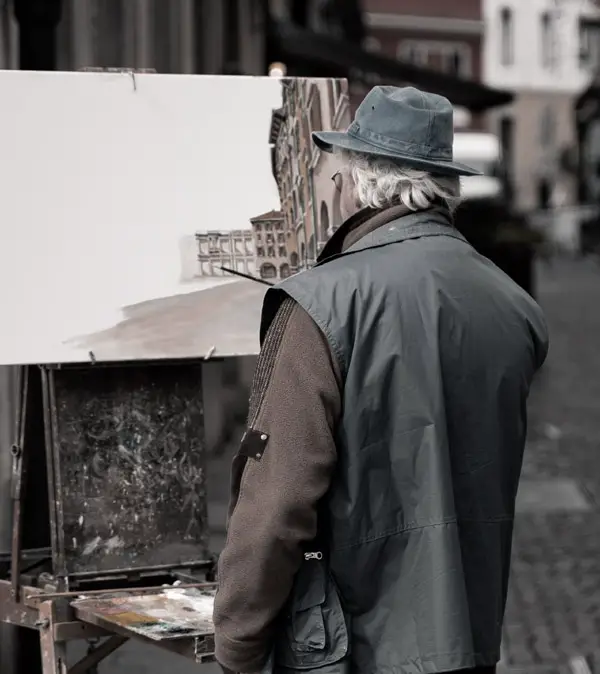 Painter laying down paint on canvas