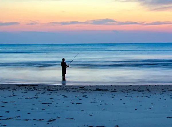 HDR photo of a fisherman in the ocean