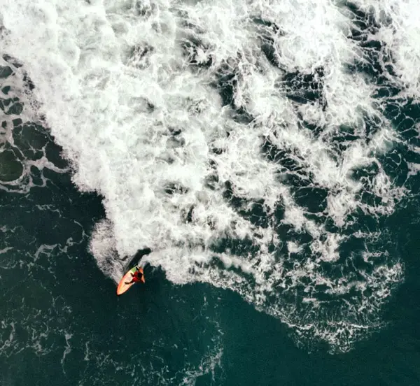 Drone shot perspective of surfer